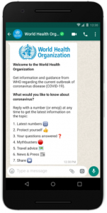 Image shows a smartphone that displays a Whats App chat with the World Health Organization.